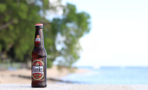 a bottle of Banks beer on the beach.