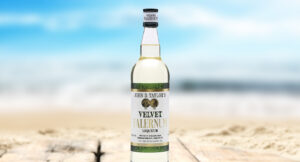 A bottle of falernum on the beach