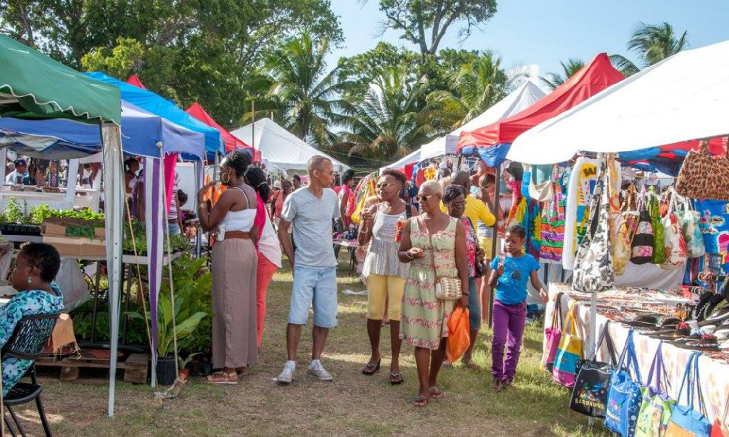 Patrons walking around and looking at stalls at Bridgetown Market during Crop Over in Barbados